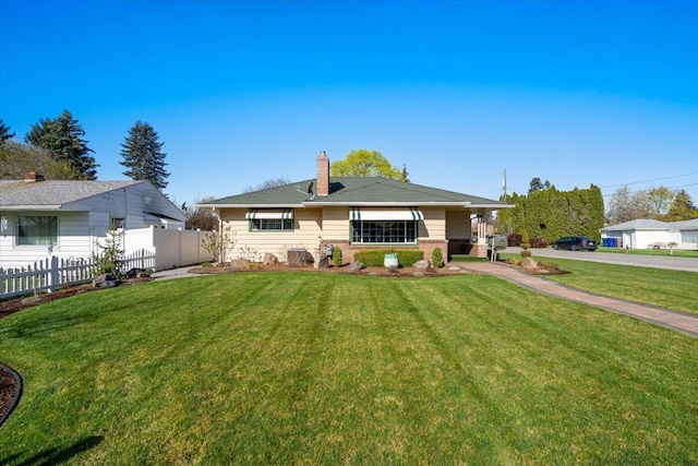exterior space with a yard, a chimney, and fence