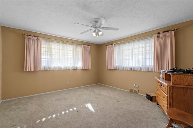 unfurnished bedroom featuring baseboards, multiple windows, and carpet