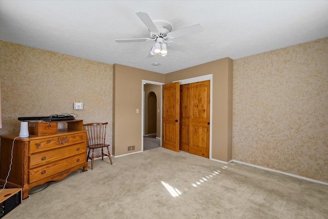 bedroom with carpet floors, visible vents, baseboards, and ceiling fan
