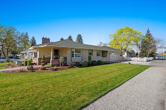 ranch-style house featuring a chimney, concrete driveway, fence, an attached garage, and a front yard