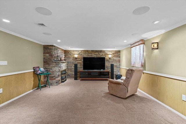 carpeted living area featuring wainscoting, wooden walls, crown molding, and visible vents