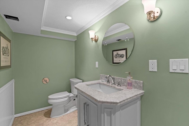 bathroom with visible vents, toilet, vanity, ornamental molding, and a textured ceiling