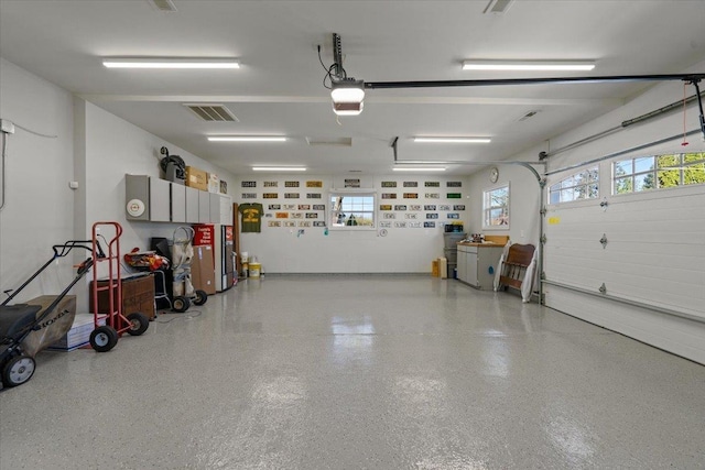 garage with a garage door opener and visible vents