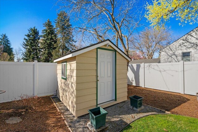 view of shed with a fenced backyard