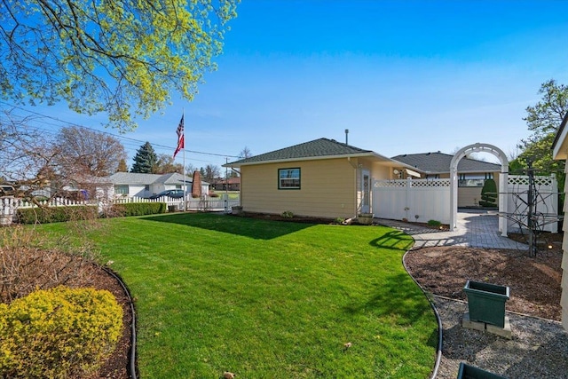 rear view of property with fence and a yard