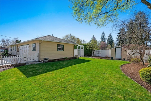 back of house with a gate, a shed, a lawn, fence private yard, and an outdoor structure