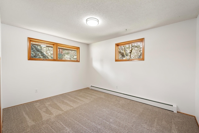 carpeted empty room with a textured ceiling and a baseboard radiator