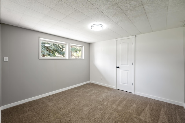 carpeted empty room featuring baseboards