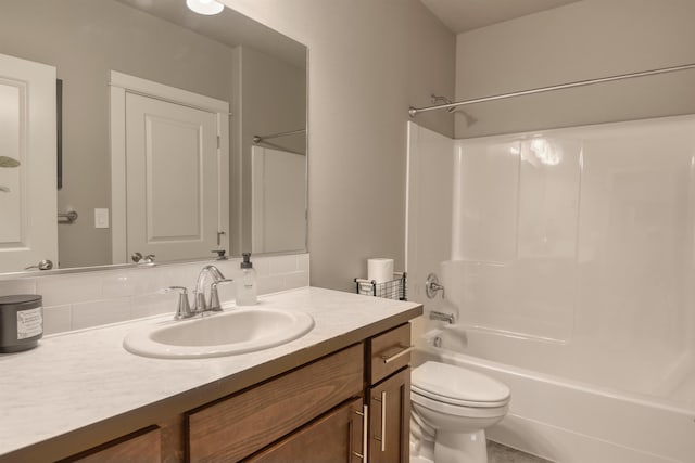 full bath featuring toilet, vanity, and  shower combination