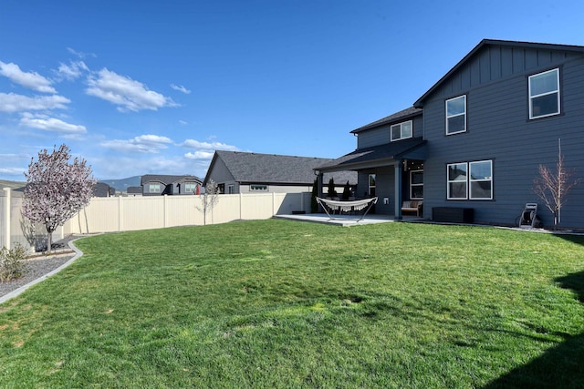 view of yard featuring central air condition unit, a patio, and fence