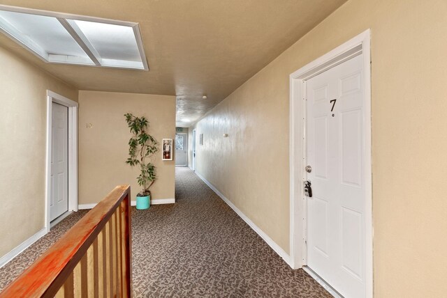 901 S Lincoln St, Spokane, WA 99204 - corridor with baseboards and dark colored carpet