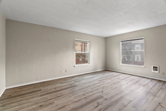 901 S Lincoln St, Spokane, WA 99204 - empty room featuring baseboards, wood finished floors, and a wealth of natural light