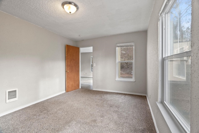 901 S Lincoln St, Spokane, WA 99204 - empty room with carpet floors, a textured ceiling, visible vents, and baseboards