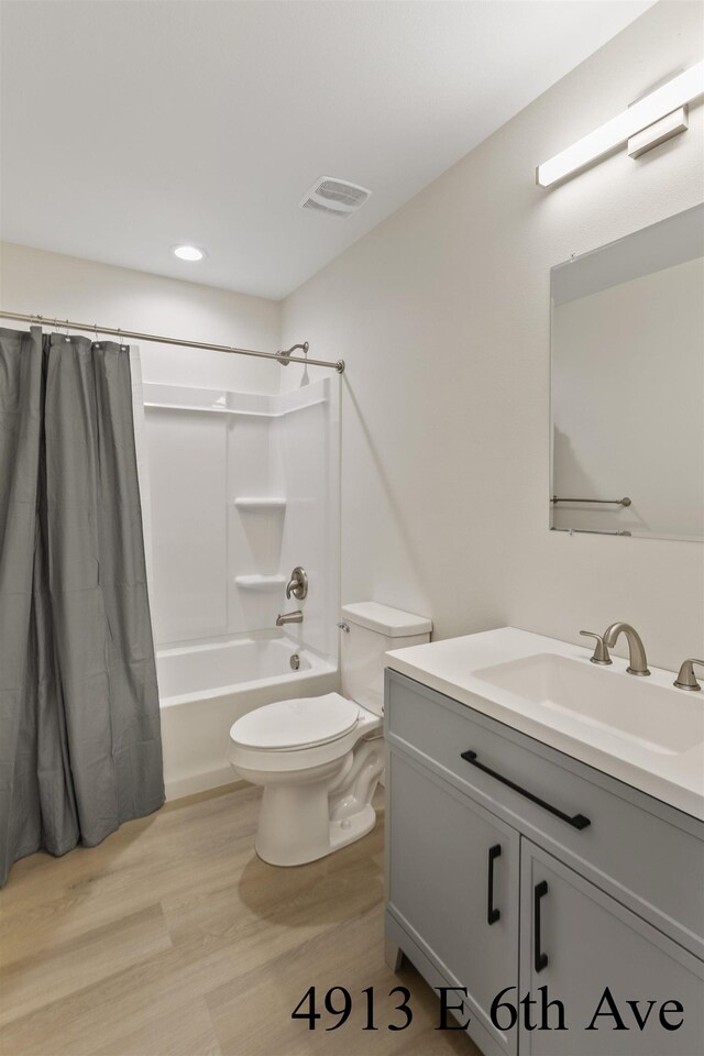4913 E 6th Avenue 4915E 6Th Ave, Spokane Valley, WA 99212 - bathroom featuring shower / bath combo, toilet, visible vents, wood finished floors, and vanity