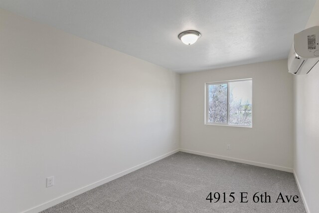 4913 E 6th Avenue 4915E 6Th Ave, Spokane Valley, WA 99212 - spare room featuring baseboards, carpet flooring, and a wall mounted air conditioner