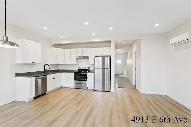 4913 E 6th Avenue 4915E 6Th Ave, Spokane Valley, WA 99212 - kitchen featuring a sink, dark countertops, under cabinet range hood, a wall mounted AC, and appliances with stainless steel finishes