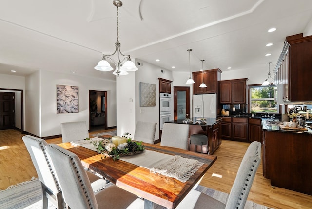 dining area featuring recessed lighting, light wood-style flooring, and baseboards