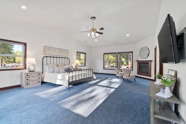 bedroom featuring lofted ceiling, a fireplace, baseboards, and carpet floors