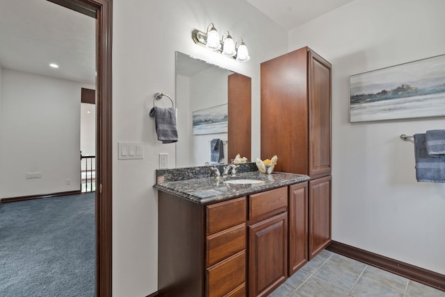 bathroom with a chandelier, baseboards, and vanity