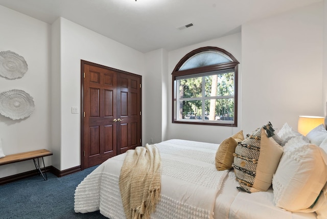 carpeted bedroom with visible vents and baseboards
