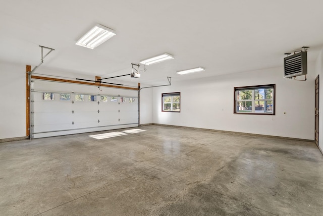 garage with baseboards and a garage door opener
