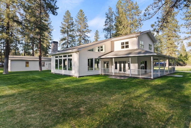 back of house with a patio area, a chimney, a yard, and french doors