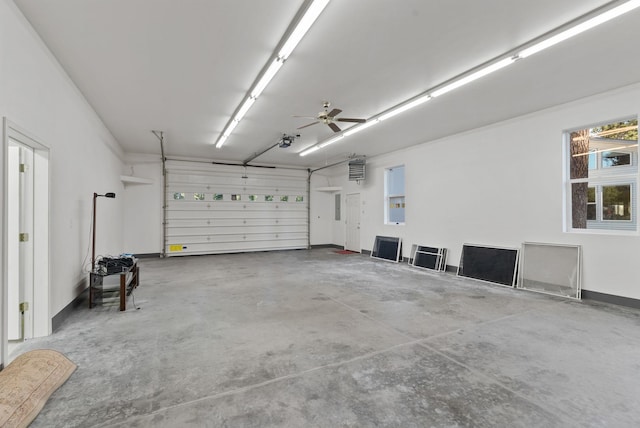 garage featuring ceiling fan, baseboards, and a garage door opener
