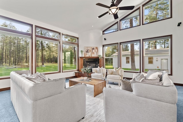living room featuring carpet floors, a wealth of natural light, and ceiling fan