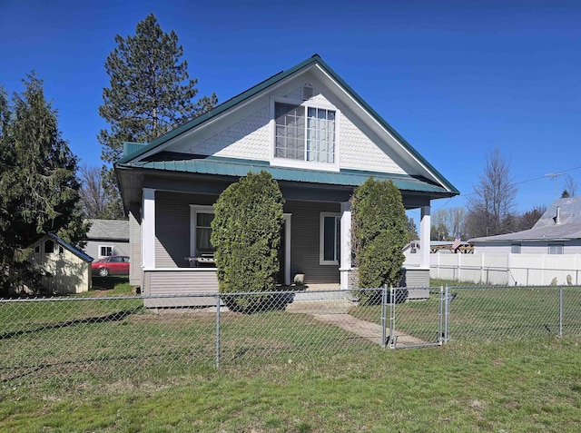 303 N Vernon St, Deer Park, WA 99006 - bungalow featuring a fenced front yard, a front yard, metal roof, and covered porch