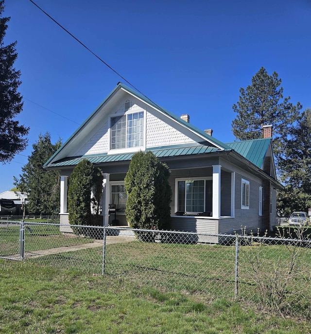 303 N Vernon St, Deer Park, WA 99006 - view of side of home with fence private yard, a lawn, a standing seam roof, and metal roof