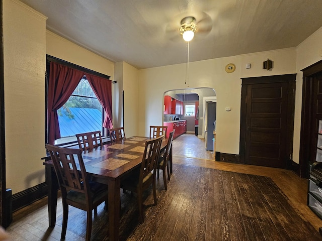 303 N Vernon St, Deer Park, WA 99006 - dining space featuring hardwood / wood-style flooring, arched walkways, ceiling fan, and a healthy amount of sunlight