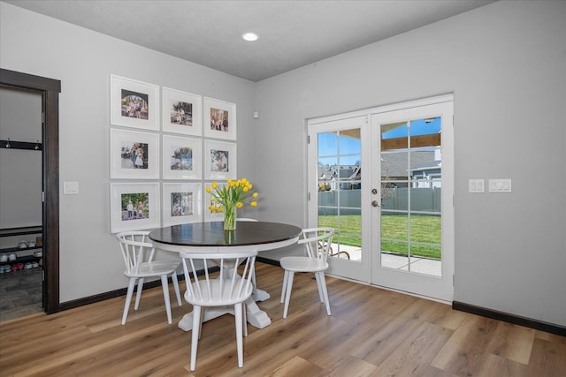 dining room featuring recessed lighting, baseboards, french doors, and light wood-type flooring