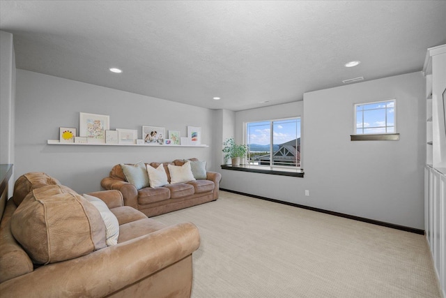 carpeted living room with plenty of natural light, visible vents, and recessed lighting