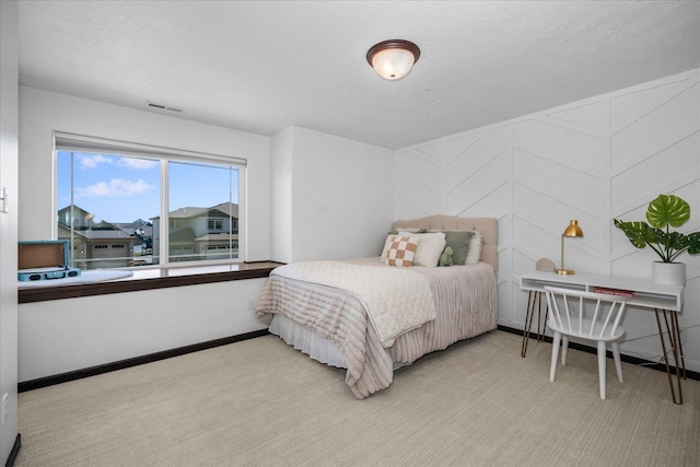 bedroom featuring baseboards, visible vents, and carpet flooring