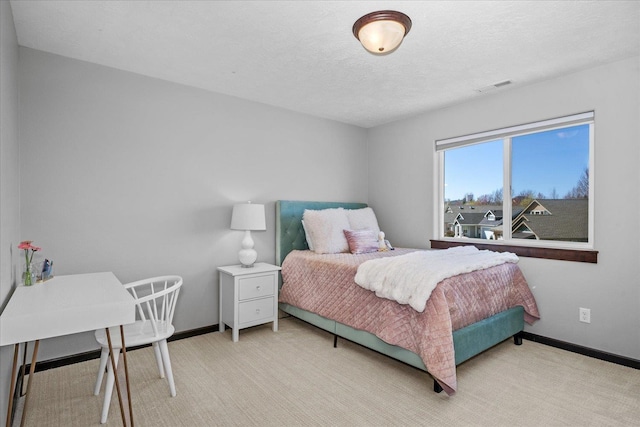 bedroom with light colored carpet, baseboards, and visible vents