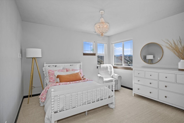 bedroom featuring light carpet, baseboards, and a chandelier