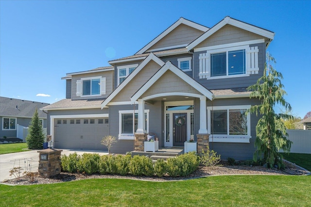 craftsman-style home with fence, driveway, a front yard, and a garage