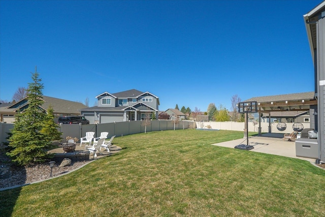view of yard featuring a patio area, a fenced backyard, and a fire pit