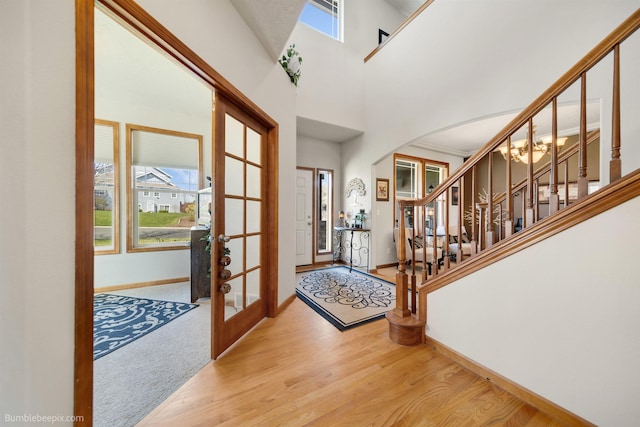 17202 E Morningside Ln, Greenacres, WA 99037 - foyer entrance featuring wood finished floors, stairs, arched walkways, french doors, and baseboards