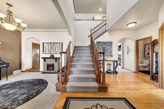 17202 E Morningside Ln, Greenacres, WA 99037 - foyer featuring a stone fireplace, baseboards, arched walkways, and a textured ceiling