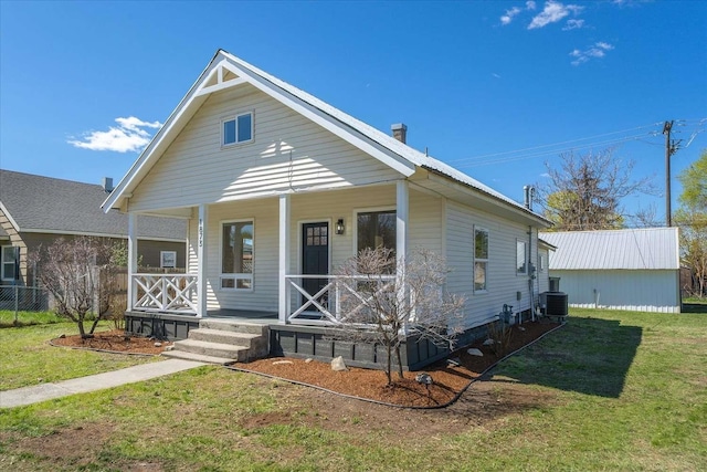 1873 E Marshall Ave, Spokane, WA 99207 - bungalow-style home with covered porch, a front yard, and central air condition unit