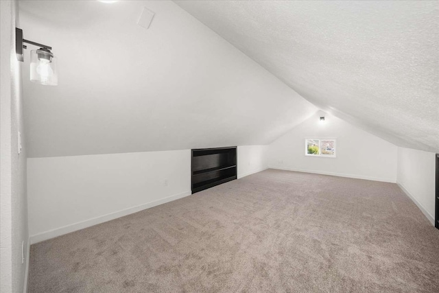 1873 E Marshall Ave, Spokane, WA 99207 - additional living space with vaulted ceiling, carpet floors, and baseboards