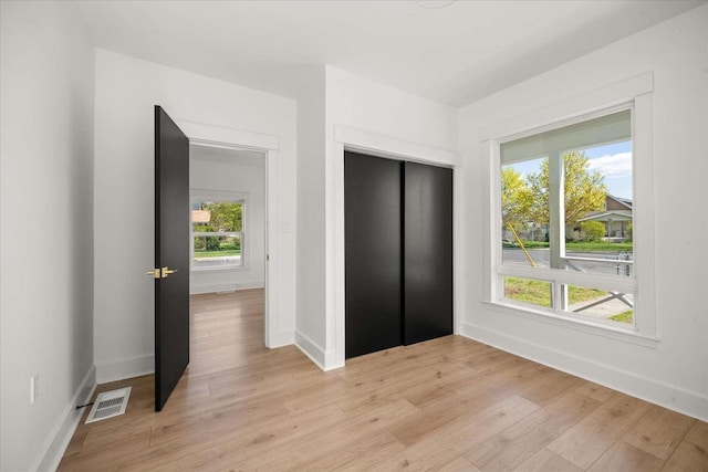 1873 E Marshall Ave, Spokane, WA 99207 - unfurnished bedroom with baseboards, elevator, visible vents, and light wood-type flooring
