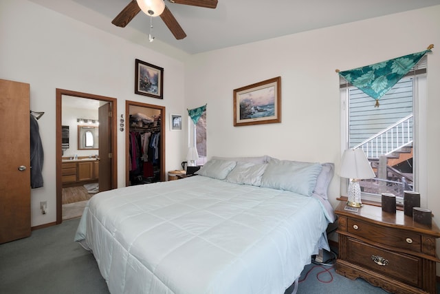bedroom with a walk in closet, carpet floors, a closet, ensuite bath, and ceiling fan