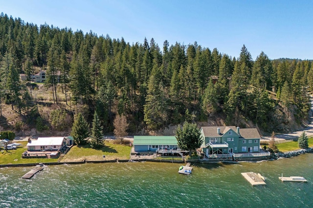 aerial view with a forest view and a water view