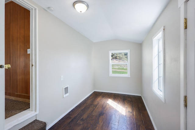 8323 W Mission Ave, Spokane, WA 99224 - spare room with baseboards, vaulted ceiling, visible vents, and dark wood-style flooring