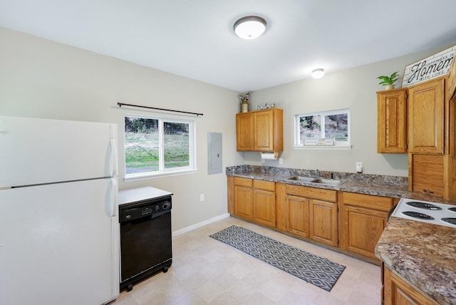 8323 W Mission Ave, Spokane, WA 99224 - kitchen featuring dishwasher, brown cabinetry, a sink, and freestanding refrigerator