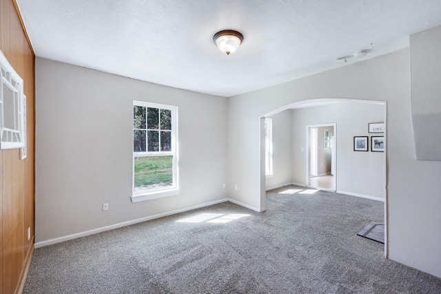8323 W Mission Ave, Spokane, WA 99224 - unfurnished room featuring carpet floors, baseboards, and arched walkways