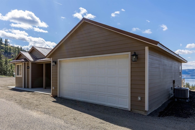 exterior space featuring an outdoor structure, central air condition unit, and metal roof