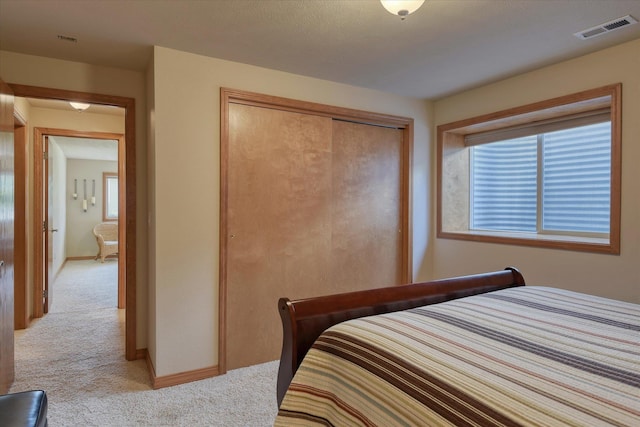 1511 N Lancashire Ln, Liberty Lake, WA 99019 - bedroom featuring baseboards, light carpet, visible vents, and a closet